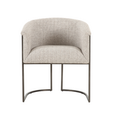 Arno Dining Chair with a comfortable fabric seat and durable steel frame, featuring a modern minimalist design ideal for contemporary kitchens and dining spaces.