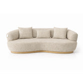 Modern curved 3 seater sofa upholstered in beige textured fabric, featuring a sculptural silhouette and comfortable deep seating ideal for contemporary living rooms.