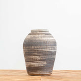 Ceramic decorative vase featuring black and white design and tactile surface, ideal for dried or fresh flowers and contemporary home styling.