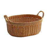 Durable oval plastic rattan storage basket with sturdy handles, perfect for organizing household essentials in style.