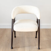 Stan Dining Chair with white fabric upholstery and black ash wood frame for a modern dining room.
