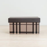 Plaid storage box in warm beige and brown tones with a sleek dark lid for stylish organization