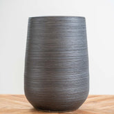 Medium black ceramic patina pot with circular textured pattern, frost-proof and ideal for indoor or outdoor plants with drainage hole