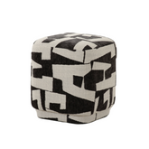 Hjo Ottoman with abstract alphabet-patterned fabric, compact modern design, and versatile use as footrest or accent seat.