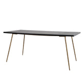 Caen Dining Table featuring a black-stained ash wood top with gold accents, showcasing a mid-century modern design perfect for luxury dining rooms.