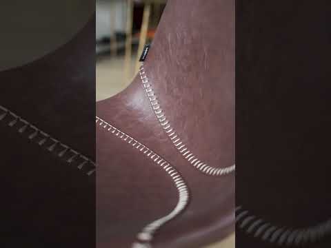 Video Close up of Marit Dining Chair in saddle brown vintage faux leather with grey stitching