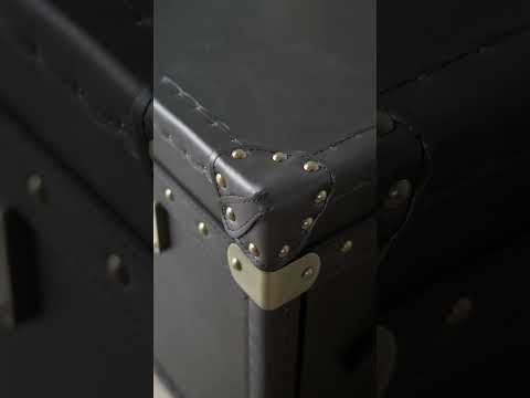 Video showcasing the Ezra Coffee Table with leather construction, metal detailing, and flip-up storage, styled as a coffee table and ottoman.