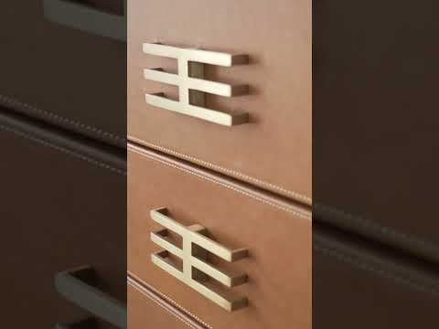 Luxury buffet cabinet with brown leather finish and gold details, a stylish sideboard for modern dining and living spaces.