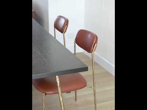 Video showcasing the Dinan Dining Chair with top-grain leather seat and forged iron frame, highlighting its classic design, comfort, and refined craftsmanship.