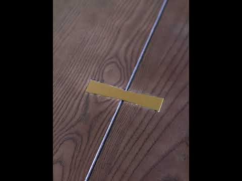 Video showcasing the Angers Dining Table featuring a rich ashwood top and detailed forged iron base in a modern dining room setting.