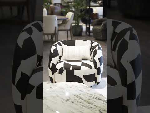Video of Aarhus Swivel Chair with abstract black-and-white design, low cradled back, and modern unique style, showcasing comfort and contemporary aesthetics.