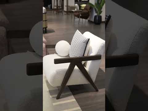 Video of Gothen Armchair upholstered in soft teddy fabric with channeled stitching and ash wood frame, showcasing modern design and comfort.