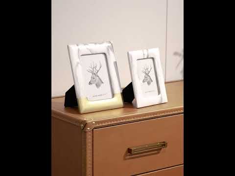 Video of the Reims Side Table showcasing its leather and canvas top, iron frame, and whimsical buckle handle in a modern bedroom and living room setting