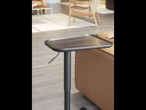 Video showcasing the Verso Table's adjustable height feature, black wood top, and iron base, highlighting its use in luxury modern interiors.