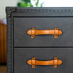 Six-drawer Albi Dresser with matte navy leather, deep brown handles, and wrought iron frame, combining industrial charm with mid-century modern luxury storage.