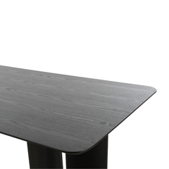 Designer Ankara dining table with artistic leg design and sleek dark ash finish, perfect as a dining room centerpiece.