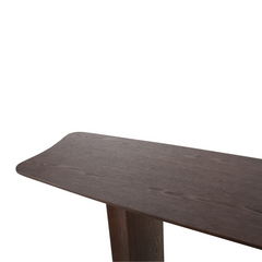 Minimalist wooden console table made of ash veneer, decorated with books and ceramics.