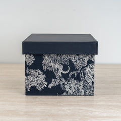 Stylish black and ivory organizer box designed to keep accessories and keepsakes neatly stored.