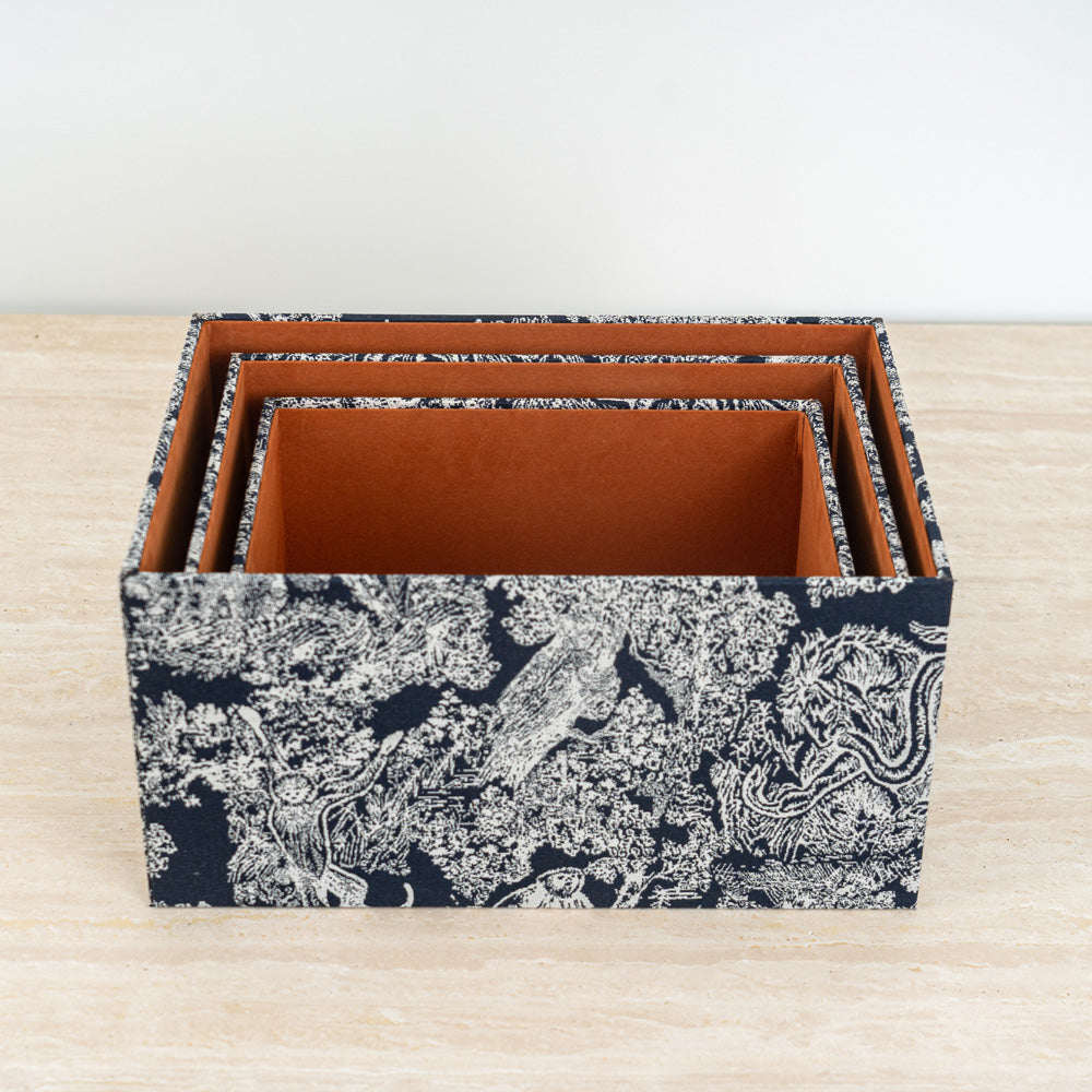 Storage box enhanced with botanical artwork and a sleek dark lid for contemporary décor.