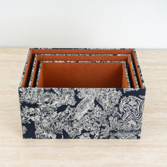 Storage box enhanced with botanical artwork and a sleek dark lid for contemporary décor.