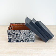 Decorative accessory case with refined black and ivory floral artwork for modern interiors.
