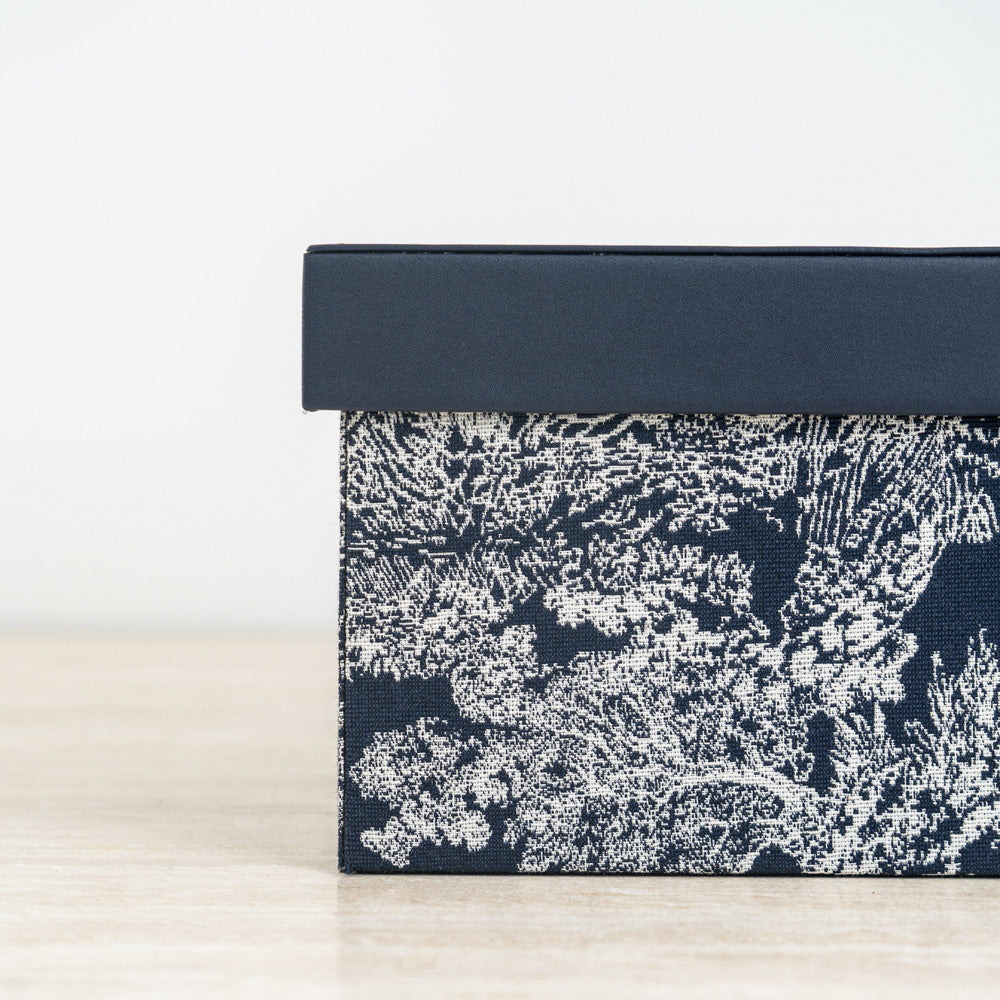 Contemporary decorative organizer box with artistic floral pattern and stackable design.