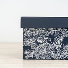 Contemporary decorative organizer box with artistic floral pattern and stackable design.