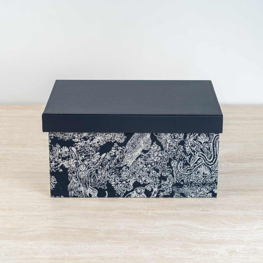 Stackable storage cube with refined botanical artwork, ideal for maximizing small spaces.