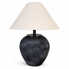 A bold black ceramic table lamp with distinctive granular finish and sculpted form.
