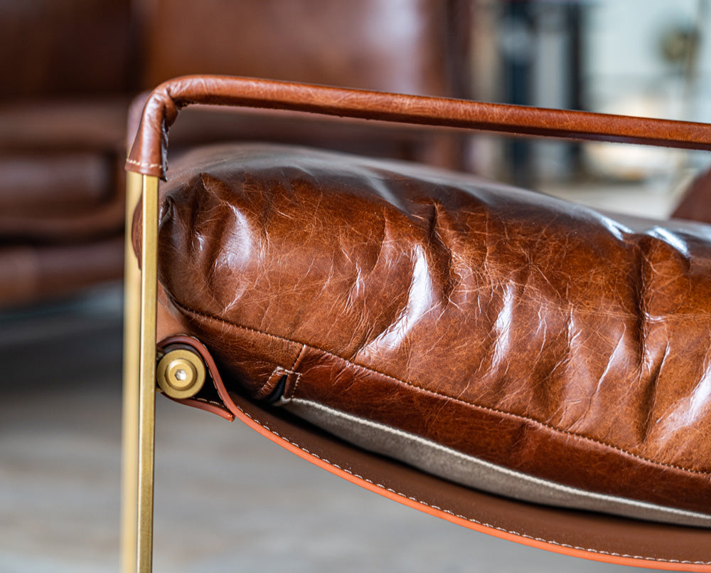 Mid-century inspired Chinon Occasional Chair upholstered in top-grain leather with PU canvas details and a durable iron frame, perfect for stylish interiors.