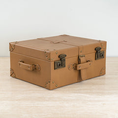 Tan faux leather decorative storage box for elegant interior décor.
