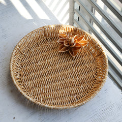 Classic round plate basket with a timeless woven look, great for organizing and displaying items throughout the home.