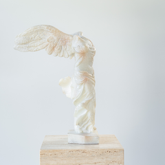Detailed reproduction of the Winged Victory statue, highlighting graceful motion and elegant sculptural details.