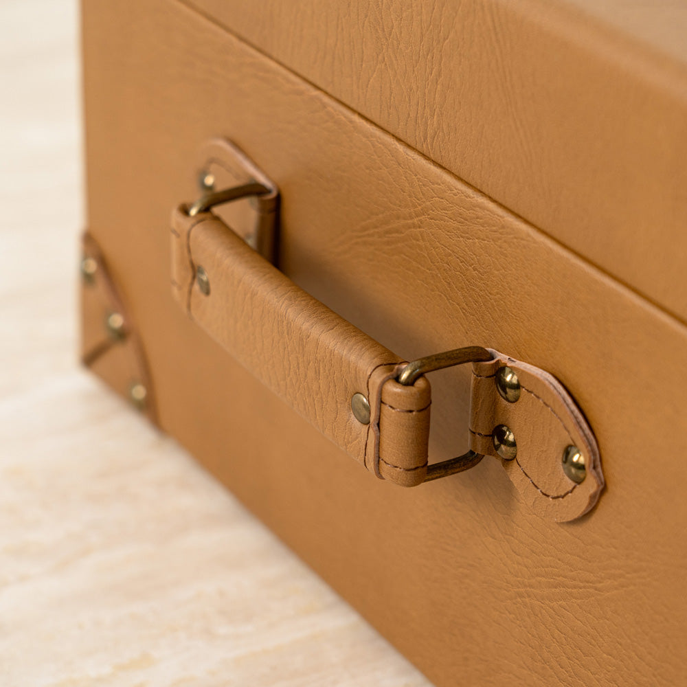 Keepsake and accessory storage chest with elegant suitcase design.