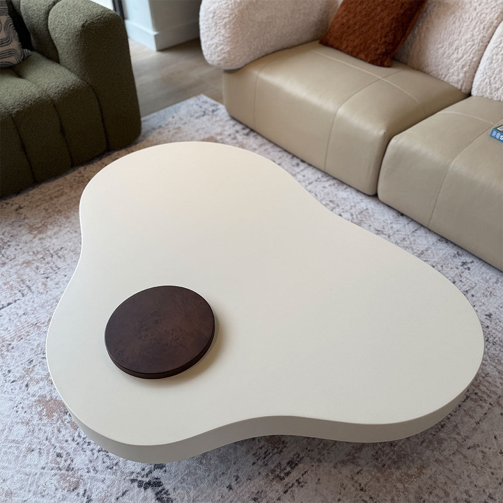 Modern coffee table with a wooden disc in a living room setting