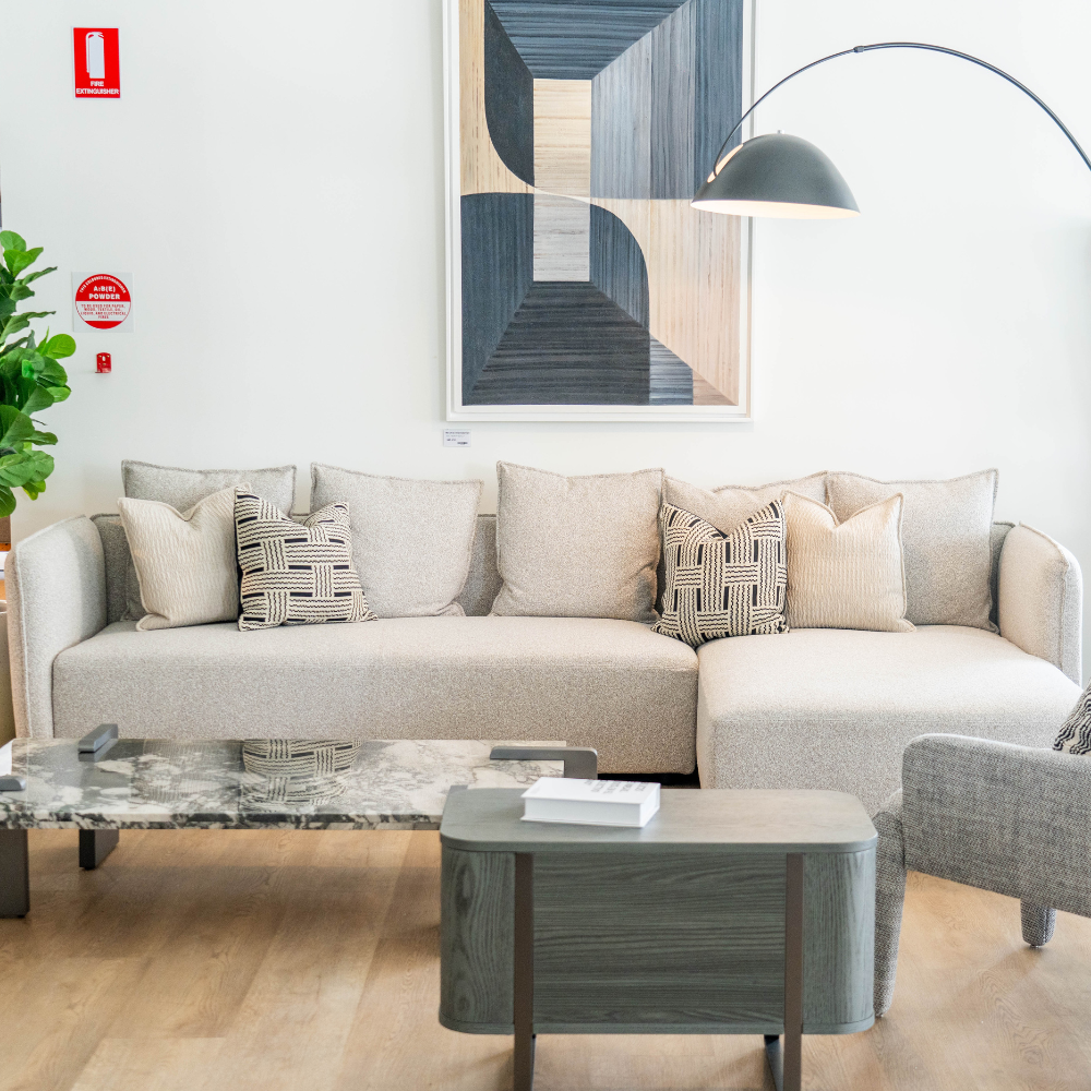 Contemporary designer L-shaped sectional with plush fabric upholstery and metal legs, ideal for luxury interiors.