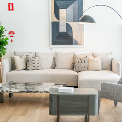 Contemporary designer L-shaped sectional with plush fabric upholstery and metal legs, ideal for luxury interiors.