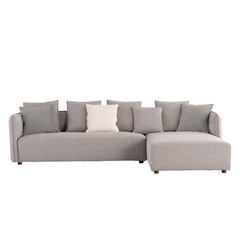 Designer L-shaped corner sofa with soft fabric upholstery, intricate arm detailing, and sturdy hardwood and metal base.