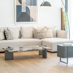 Elegant L-shaped sofa featuring high-quality fabric, plush cushioning, and sleek metal legs for contemporary interiors.