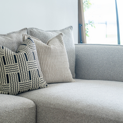 Luxury plush fabric L-shaped lounge sofa with square silhouette, durable frame, and elegant arm detailing.
