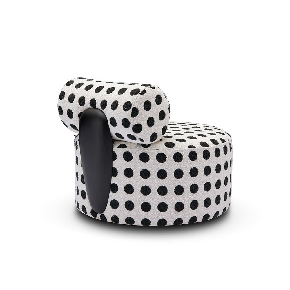 Bold contemporary accent chair with black and white upholstery back view showcasing metal detail.