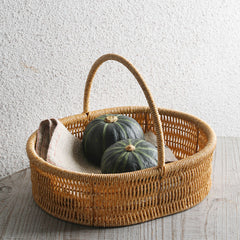 Decorative shallow oval plastic rattan basket with handle, perfect for home organization, accessories, or as a gift basket.