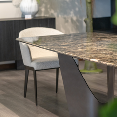 The Otto Dining Table styled in a luxury dining room setting, showcasing the polished diamond marble top and matte black base.