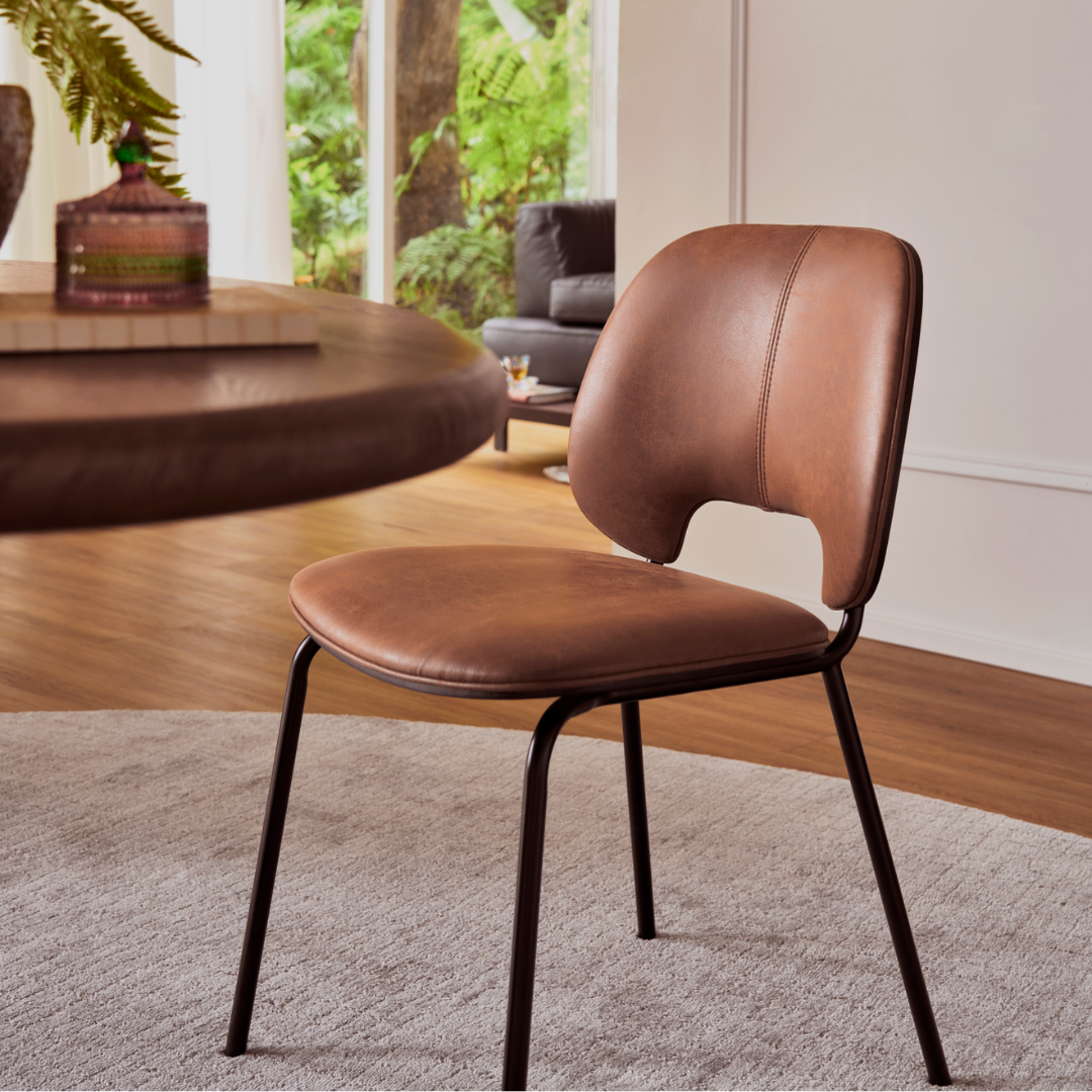 Vintage brown oil wax cloth dining chair with steel legs paired with walnut table
