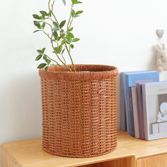 Durable plastic rattan organizer basket, perfect for stylishly keeping household essentials tidy.