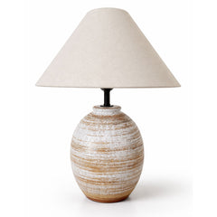 Showcasing layered white and clay-toned banding, this rounded ceramic table lamp brings warmth and natural depth to relaxed contemporary interiors.
