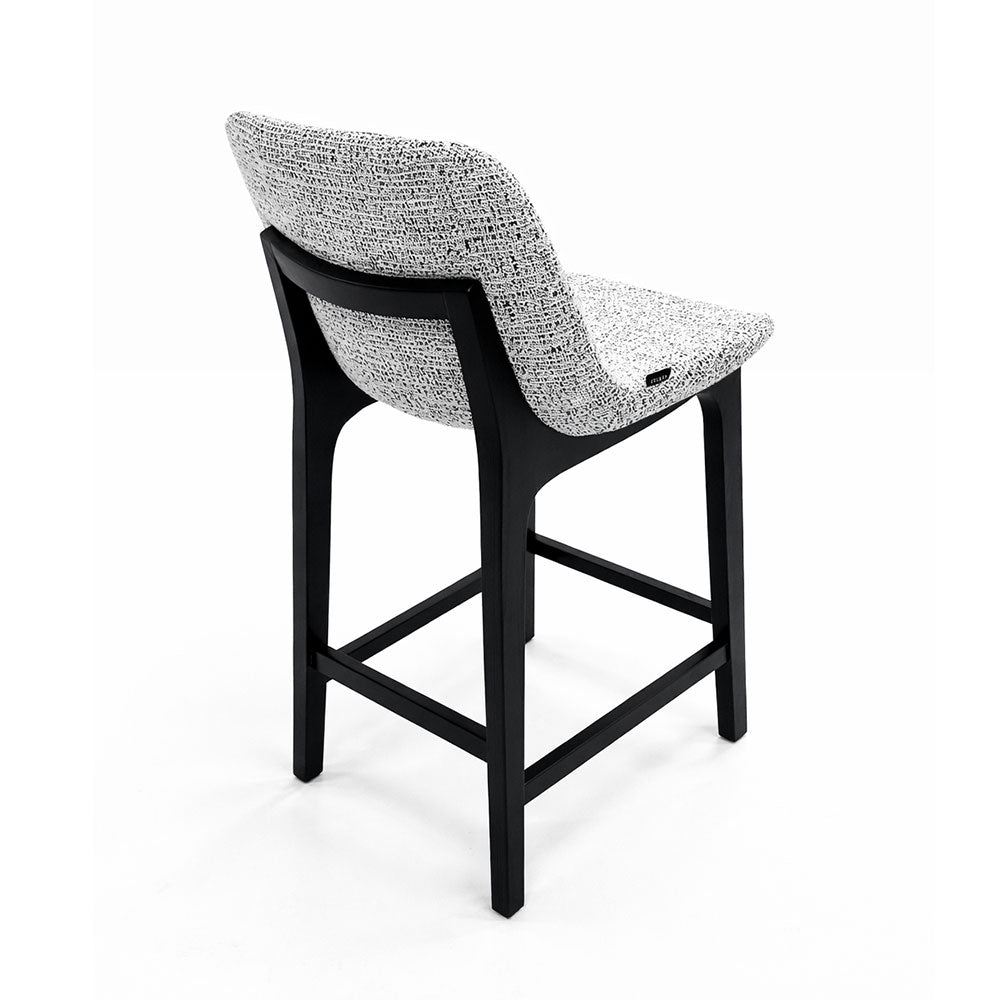 Timeless counter-height stool with grey fabric seating and dark ash wood legs, combining comfort and durability for everyday use.