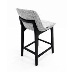 Timeless counter-height stool with grey fabric seating and dark ash wood legs, combining comfort and durability for everyday use.