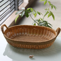 Elegant oval rattan-style basket with sturdy handles, designed for organizing accessories, toiletries, or decorative items.