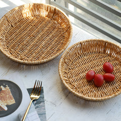 Elegant round plate-style basket crafted from durable plastic rattan, ideal for stylish home storage and decorative use.